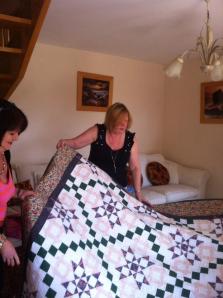 Anne opening her quilt